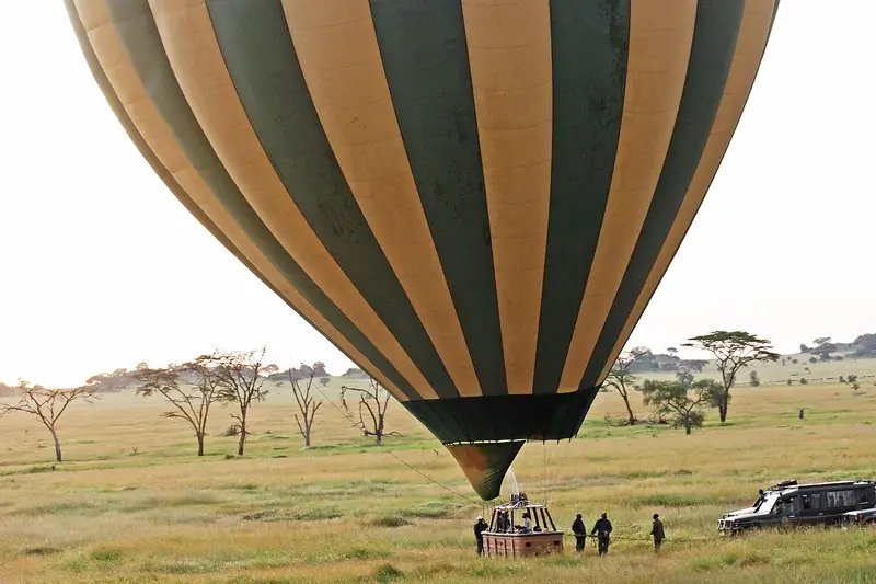 Hot air balloon landing on the Serengeti plains