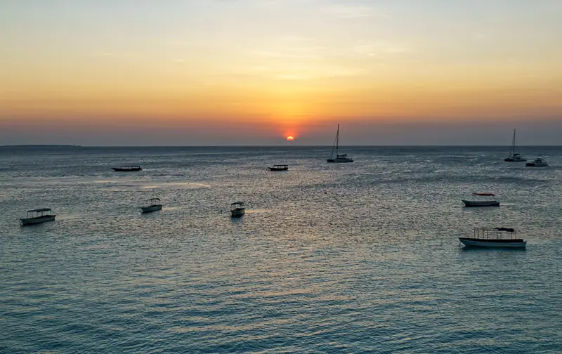 Sunset over boats at Nungwi