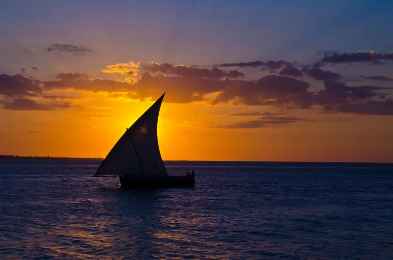Dhow silhouetted at sunset off Zanzibar